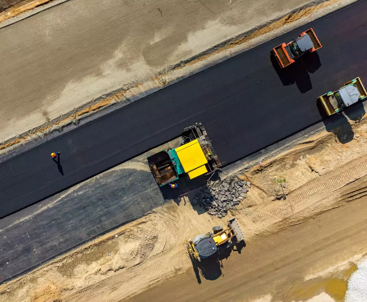 Arial view of construction workers working on road.