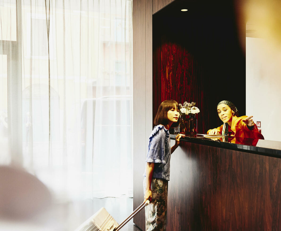 Hotel receptions giving directions to a hotel guest.
 Hotel receptions giving directions to a hotel guest.