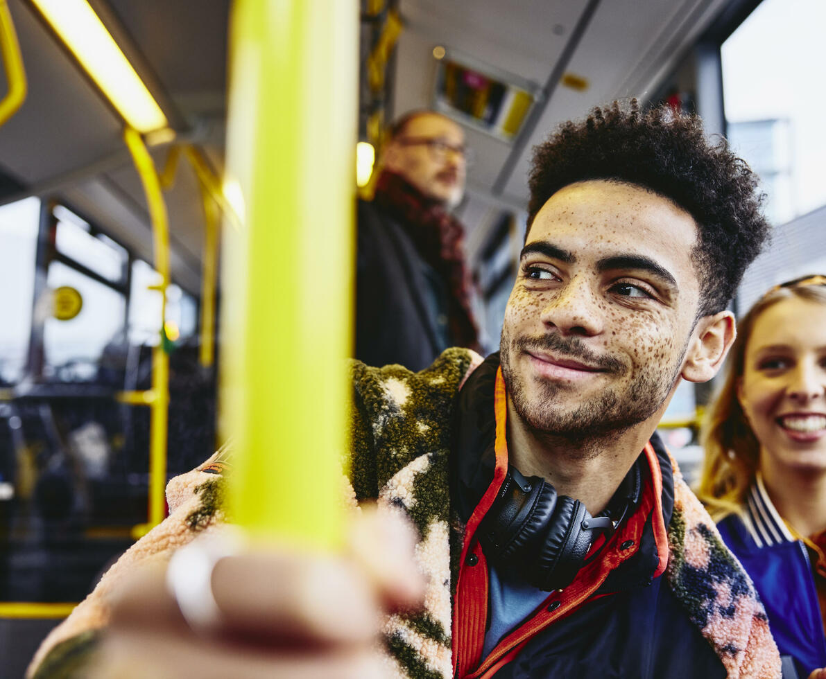 Womale and boy smiling, sitting in a bus.
 Womale and boy smiling, sitting in a bus.
