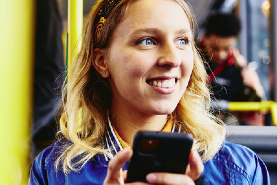 Woman on bus using phone Woman on bus using phone
