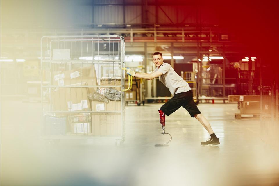 Please use these images in the context of inclusion projects Worker pushing a trolley in a warehouse