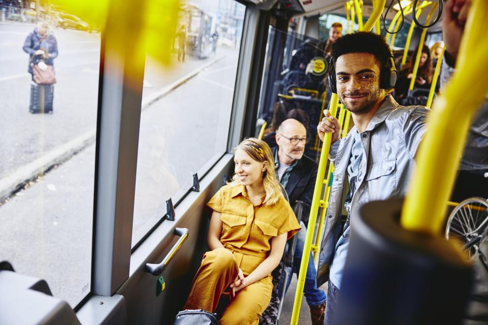 Smiling people looking outside from the bus. Smiling people looking outside from the bus.